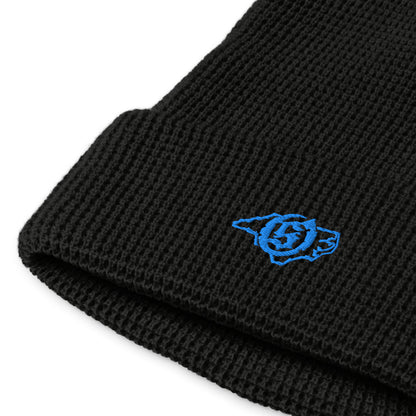 Sail On NC waffle beanie in Black with blue thread embroidered logo, close-up view
